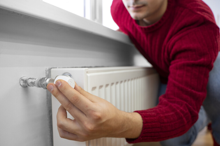 Man using switch on radiator