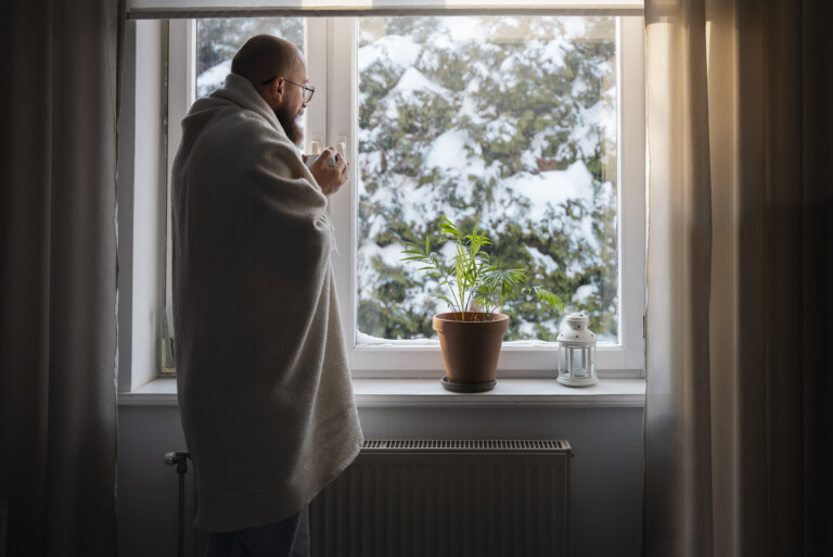 Man looking at winter weather outside