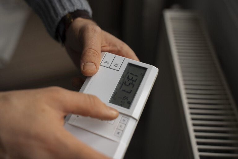 man using thermostat