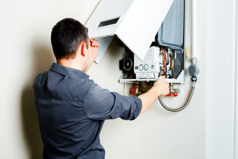 Engineer repairing a gas boiler