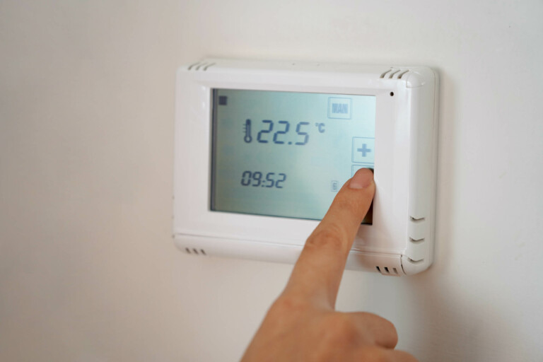 Homeowner using a thermostat