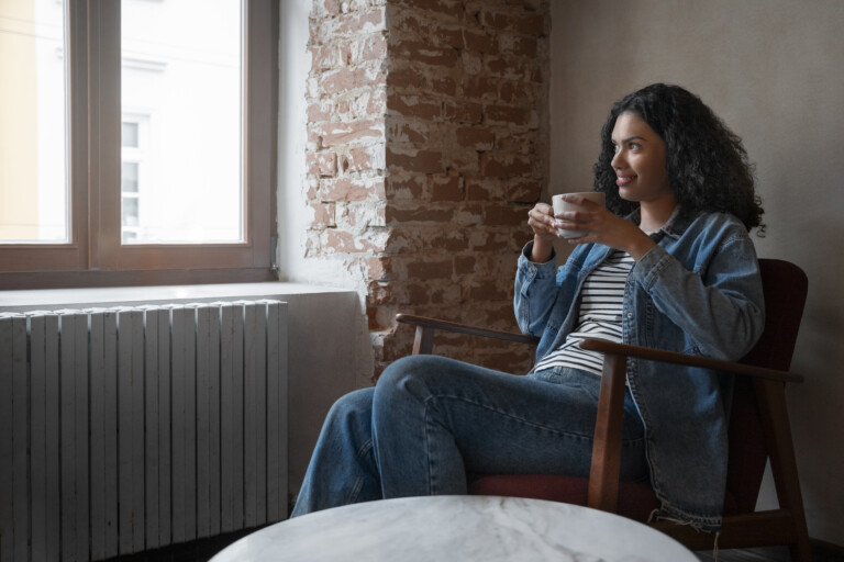 Woman drinking coffee at home