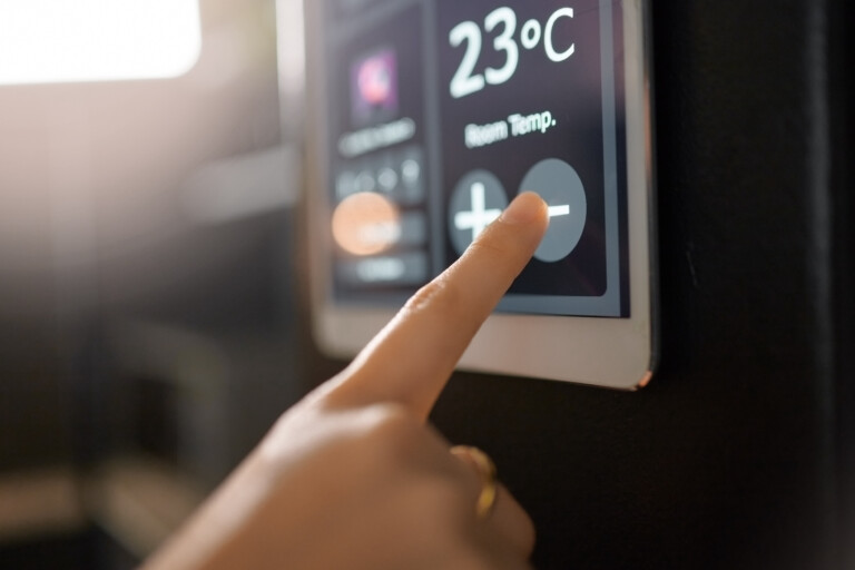 Smart home system, wall and woman hands with digital app monitor for thermostat heating, temperature control or house automation. Future AI software, ui air conditioning panel and girl with IOT tech.